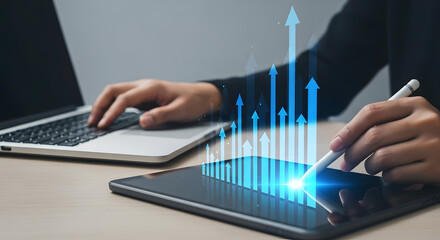 Person working on a laptop and tablet, visualizing business growth with digital arrows.