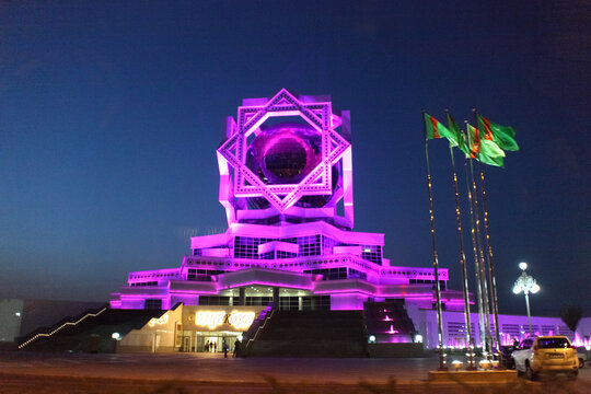 2nd of September 2023. Palace of Weddings in Ashgabat illuminated at night with green lights and symmetrical futuristic design. C.