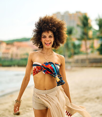 Portrait of young happy beautiful asian woman walking and running and having fun on the beach during summer vacation