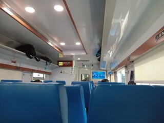 Modern Passenger Train Interior with Overhead Luggage Storage