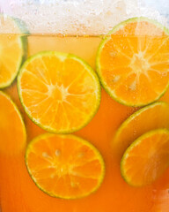 Fresh orange juice and slice in a refreshing glass.