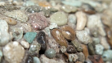 close up small stones arranged on the wall