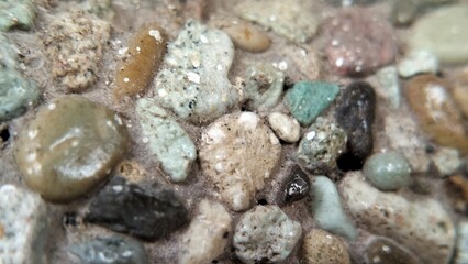 close up small stones arranged on the wall