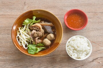 boiled braised beef meat and tendon couple organ in herb brown soup on bowl dipping spicy chili sauce eat couple with plain rice