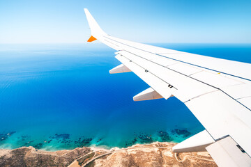 Turquoise sea seen from the wing of an airplane, island of Cyprus.