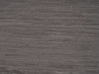 A tapestry of charcoal and graphite hues woven into the robust texture of walnut wood veneer