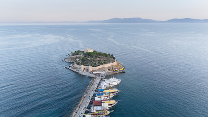 Aerial view of Guvercinada Island (Pigeon Island) with scenic castle at Kusadasi, Turkey. The large resort town is a popular tourist destination in Turkey.