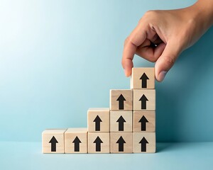 Hand placing final block on upward trending arrow staircase