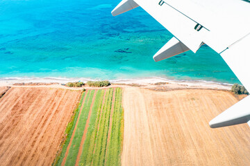 A picturesque holiday island with a turquoise sea seen from a plane, Cyprus.