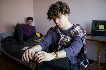 Young adults engage in creative leisure at home during a cozy afternoon in a warm and inviting shared space
