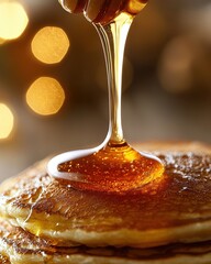 Drizzling Honey on Stack of Golden Brown Fluffy Pancakes