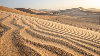 Naklejka premium Desert sand dunes with wind patterns, golden sand texture landscape, natural wavy lines, minimal warm sunset light, nature background