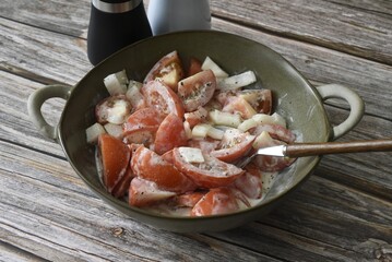 Tomato and onion salad with cream, salt and freshly ground pepper.
