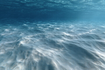 Fototapeta premium Underwater scene featuring sunlight filtering through the water, creating a shimmering effect, highlighting the textures of the water and the depths below