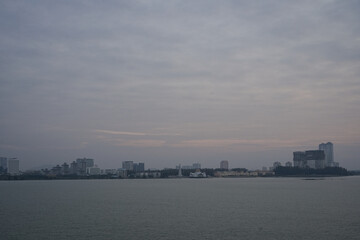 Fototapeta premium urban waterfront city skyline with overcast sky at dawn in singapore