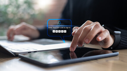 User hand entering OTP code on tablet for secure login. Concept of cybersecurity, two-factor...