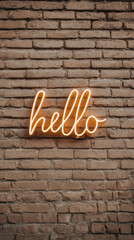 Hello neon sign glowing on brick wall background