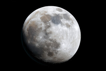 Fototapeta premium A close-up shot of the moon shining brightly in the night sky, displaying its craters and detailed surface 