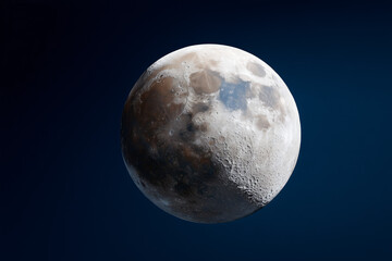 A detailed close-up shot of the moon set against a backdrop of deep, dark space, a celestial body with textures and shadows