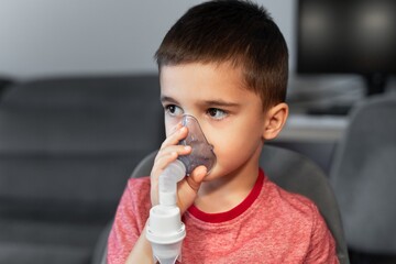 Little Boy Using a Nebulizer at Home