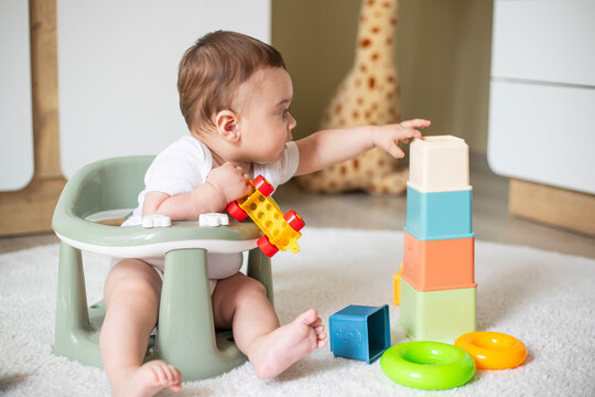 Developmental Toys. Cute Infant Baby Playing With Colorful Building Blocks At Home