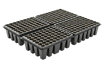Naklejka premium Set of four black plastic seedling trays filled with potting soil isolated on a transparent background