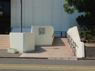 A ramp leading to the building's entrance, designed for people with disabilities, the elderly, pregnant women, and families with young children.