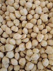 Detailed view of dried nutmeg fruits with rough outer shells. Suitable for spice, herbal medicine, or organic product visuals.