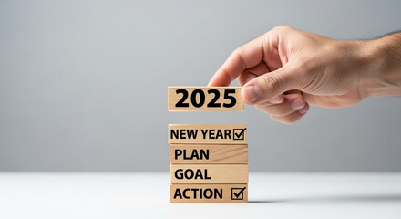 New Year goals for 2025, hand arranging wood blocks, resolution, planning, action concept.