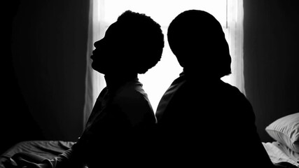 A couple quarreling concept of family relationship problems divorce, black silhouette of man and woman sitting at bed back to back resentment towards each other window in dark room - Powered by Adobe