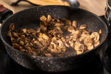Mushrooms are being, cozy kitchen setting adds warmth to the dinner preparation atmosphere.