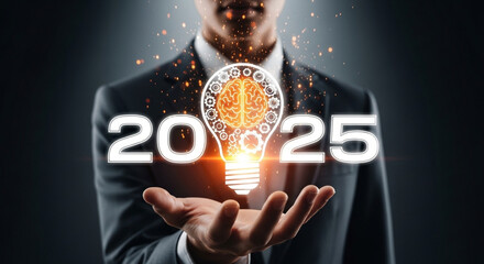 Light bulb in businessman’s hand, gear symbol, 2025 business goals, technology-driven inspiration concept.