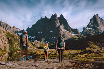 Active family adventure in Norway father, mother and child explore Lofoten islands active healthy lifestyle hobby summer vacations hiking group tour outdoor in rocky mountains with backpacks climbing © EVERST