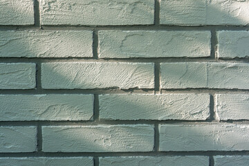 Decorative plaster in the form of white brick on the wall