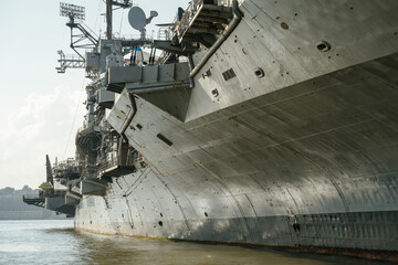 Side view of the USS showing its steel hull, radar tower, and deck structures. The photo captures...