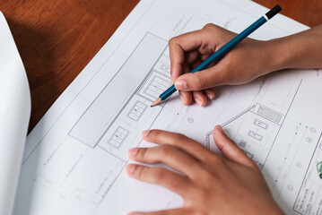 Exploring architectural design sketching plans at a desk home office blueprinting creative space hands-on perspective