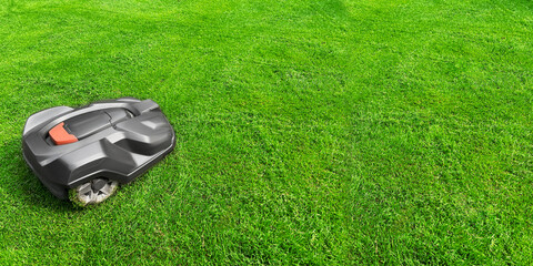 Lawn mower on lush bright green grass outdoors, banner design