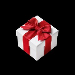 Obraz premium Elegant White Gift Box with Red Ribbon on Black Background for Celebrations and Special Occasions