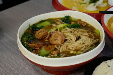 delicious asian noodle dish with grilled pork and vegetables on a plate