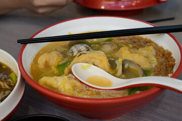 Delicious Asian Soup Bowl with Clams and Fried Ingredients in Vibrant Colors