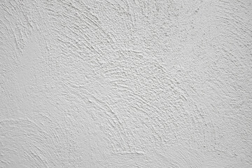 The cement wall is in white, off-white, and has a pale-yellow tone; the wall has a line texture pattern.