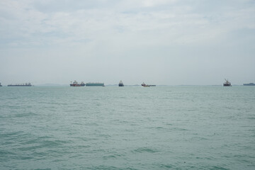 Obraz premium seascape with cargo ships and clear sky on a calm day