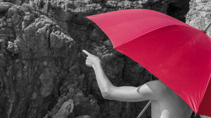 Man hold red umbrella and points a finger