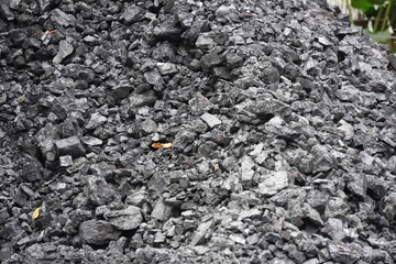 Close-Up of Crushed Charcoal with Irregular Shapes and Rough Texture in Outdoor Setting
