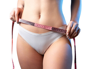 A young slim fit girl with a measuring tape at her waist poses in the studio.