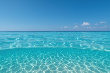 Obraz premium Spectacular above-below water composition showcasing pristine turquoise ocean meeting brilliant azure sky with puffy white clouds