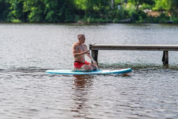 A man paddles on a SUP board.