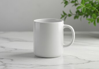 A clean white ceramic mug rests on a marble surface with a plant in the background