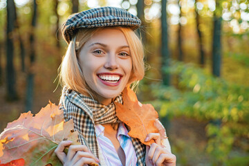 Autumn face of happy young woman. Smiling girl on autumn fall background. Beauty girl with fall...