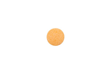 Orange tablet of vitamin C, a health supplement for immunity support. Macro closeup of a single...